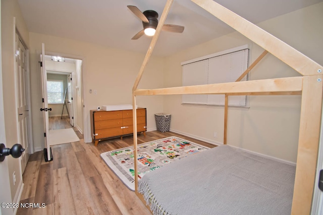 bedroom featuring light hardwood / wood-style floors, a closet, and ceiling fan