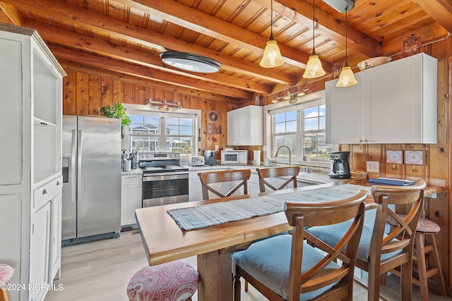 living room with wood walls, ceiling fan, wooden ceiling, and light wood-type flooring