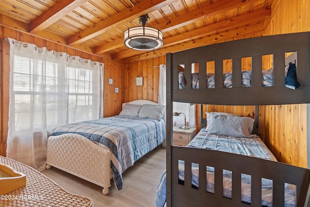 dining area featuring wood walls, light hardwood / wood-style flooring, and ceiling fan