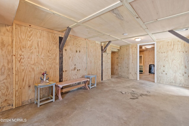 bedroom with wooden walls, beamed ceiling, light hardwood / wood-style floors, and wooden ceiling