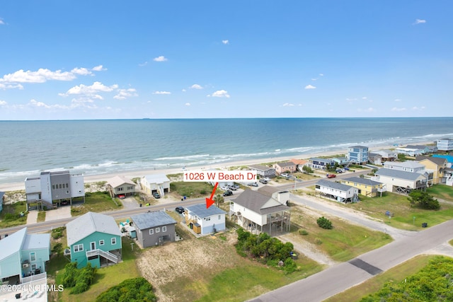 birds eye view of property with a view of the beach and a water view