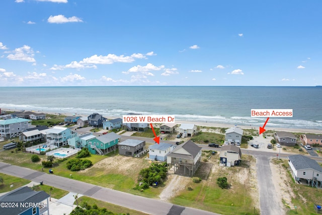 bird's eye view featuring a water view and a view of the beach