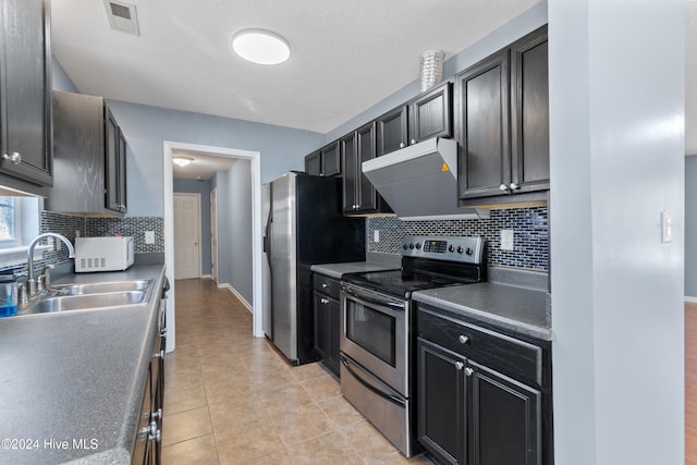 kitchen with stainless steel range with electric stovetop, light tile patterned flooring, sink, and tasteful backsplash