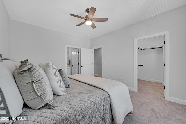 carpeted bedroom with a closet, ceiling fan, connected bathroom, and a spacious closet