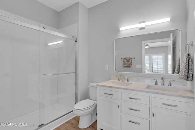 bathroom with vanity, an enclosed shower, hardwood / wood-style floors, toilet, and ceiling fan