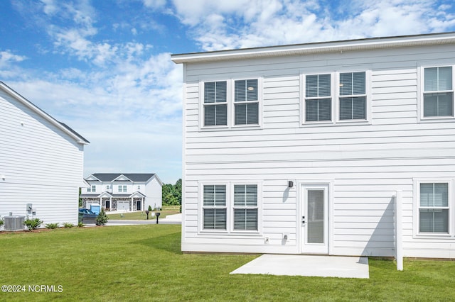 rear view of house with a patio area, a yard, and central AC unit