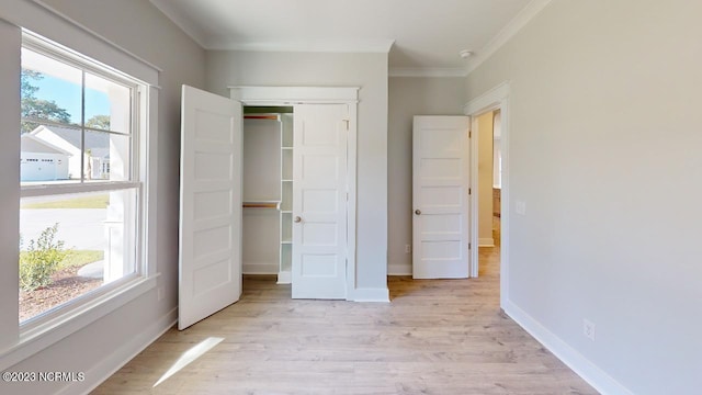 2090 Greenside Manor Dr Unit L-39, Ocean Isle Beach, NC 28469 - unfurnished bedroom with crown molding, a closet, and light wood-style floors