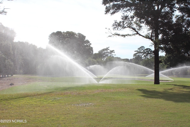 2090 Greenside Manor Dr Unit L-39, Ocean Isle Beach, NC 28469 - surrounding community with a yard, golf course view, and a water view