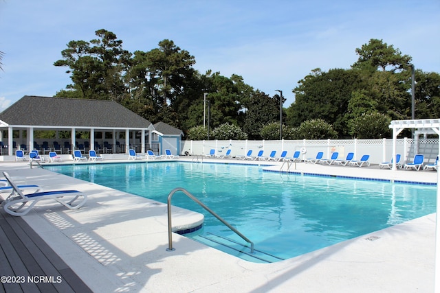 2090 Greenside Manor Dr Unit L-39, Ocean Isle Beach, NC 28469 - community pool with a patio area, view of wooded area, and a pergola