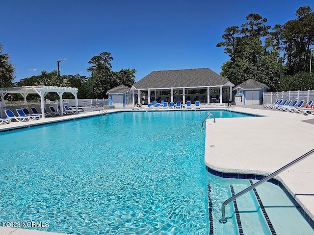 2090 Greenside Manor Dr Unit L-39, Ocean Isle Beach, NC 28469 - community pool with a pergola, a patio area, and a shed