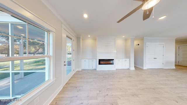2090 Greenside Manor Dr Unit L-39, Ocean Isle Beach, NC 28469 - unfurnished living room with a glass covered fireplace, crown molding, ceiling fan, light wood-style floors, and recessed lighting