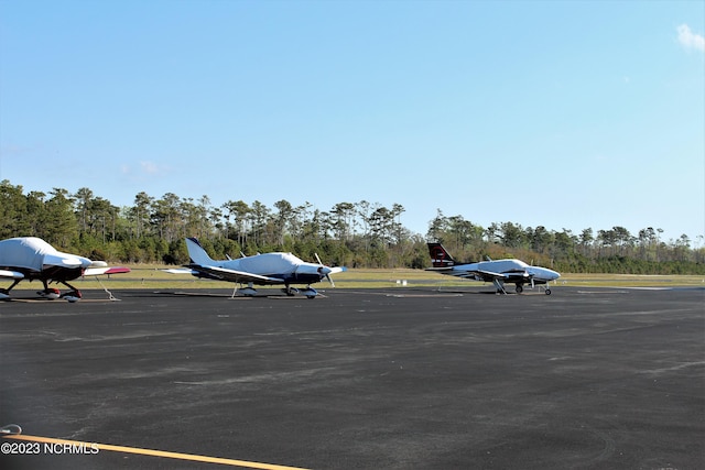 2090 Greenside Manor Dr Unit L-39, Ocean Isle Beach, NC 28469 - uncovered parking lot with view of wooded area