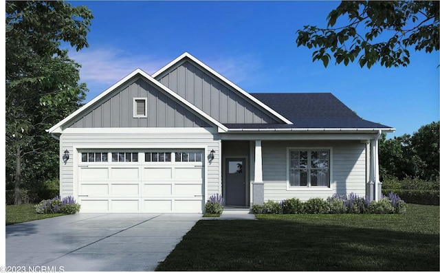 2090 Greenside Manor Dr Unit L-39, Ocean Isle Beach, NC 28469 - view of front facade with board and batten siding, driveway, a front yard, and an attached garage