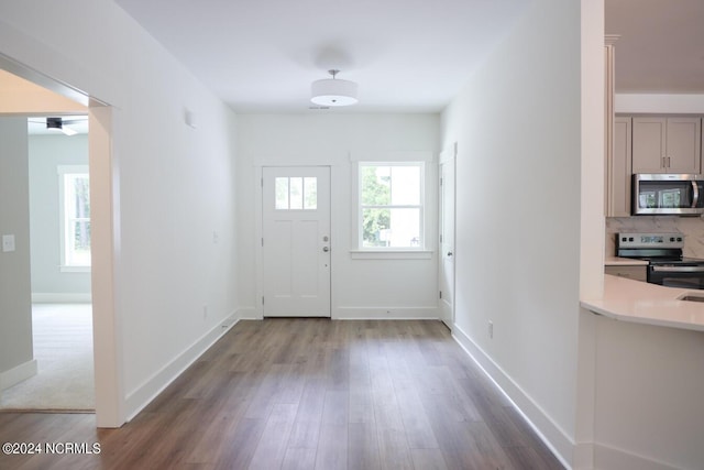 235 Weathersbee Dr, Hampstead, NC 28443 - doorway featuring baseboards and wood finished floors