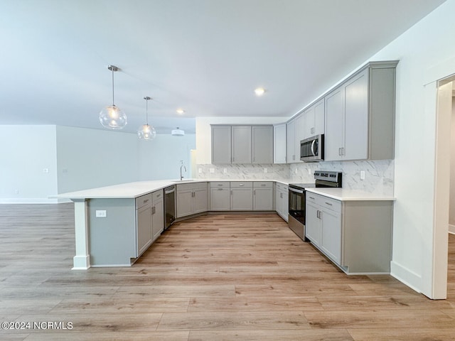 235 Weathersbee Dr, Hampstead, NC 28443 - kitchen with gray cabinetry, stainless steel appliances, a peninsula, and a sink