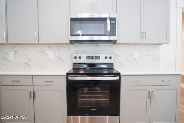 235 Weathersbee Dr, Hampstead, NC 28443 - kitchen featuring light countertops, gray cabinets, appliances with stainless steel finishes, and backsplash