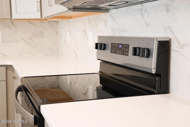 235 Weathersbee Dr, Hampstead, NC 28443 - kitchen featuring light countertops, white cabinetry, stainless steel electric stove, and tasteful backsplash