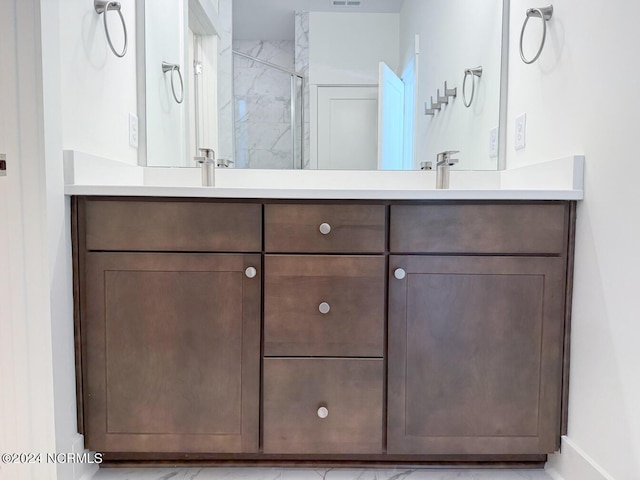 235 Weathersbee Dr, Hampstead, NC 28443 - bathroom featuring baseboards, double vanity, a sink, and walk in shower