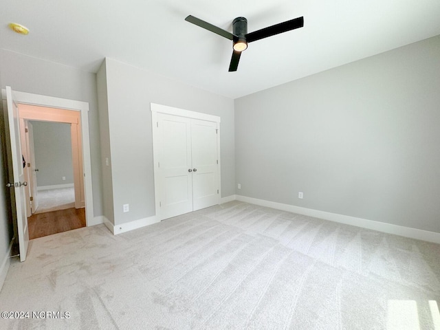 235 Weathersbee Dr, Hampstead, NC 28443 - unfurnished bedroom featuring baseboards, light colored carpet, ceiling fan, and a closet