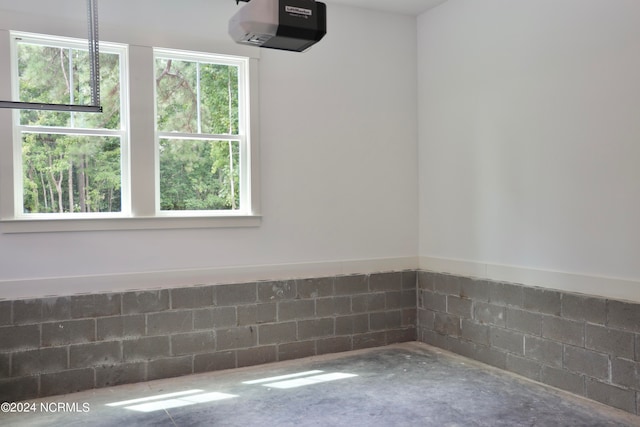 235 Weathersbee Dr, Hampstead, NC 28443 - interior space with concrete block wall, a garage door opener, and concrete floors