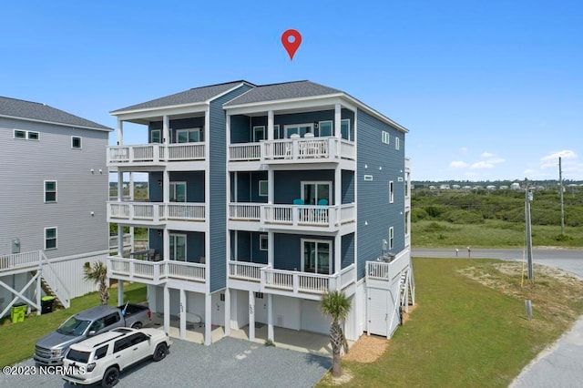 back of property featuring a yard and a balcony