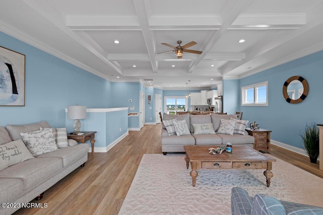 living room with coffered ceiling, light hardwood / wood-style floors, ceiling fan, and a wealth of natural light