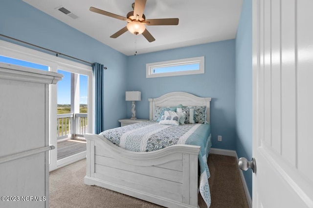 carpeted bedroom with ceiling fan and multiple windows