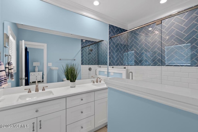 bathroom with walk in shower, double vanity, and ornamental molding