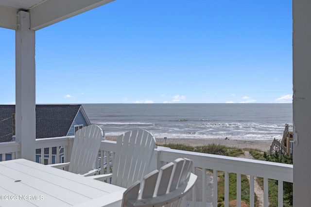 exterior space with a water view and a beach view