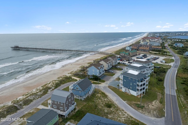 drone / aerial view with a beach view and a water view