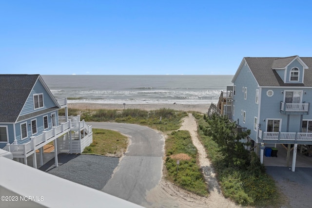 exterior space featuring a beach view and a water view