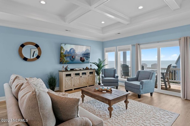 living room with coffered ceiling, beamed ceiling, light hardwood / wood-style floors, crown molding, and a water view