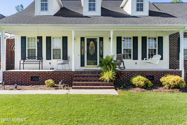 view of front of house featuring a porch and a front lawn