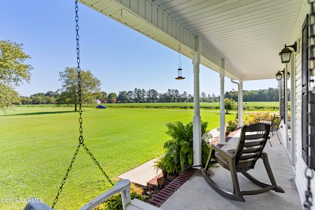 view of patio with a porch and a rural view