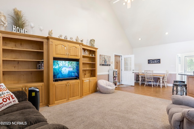 living room with ceiling fan and high vaulted ceiling