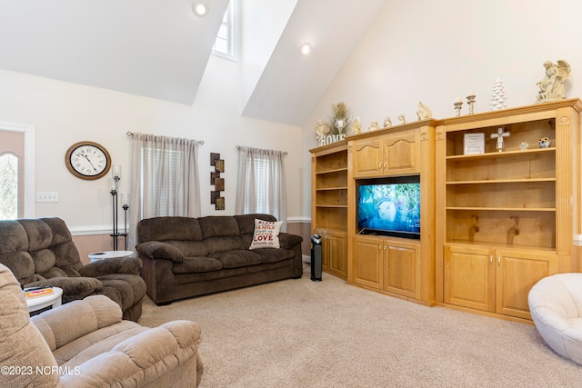 carpeted living room featuring high vaulted ceiling