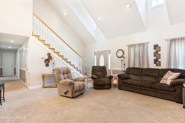 living room featuring carpet flooring and high vaulted ceiling