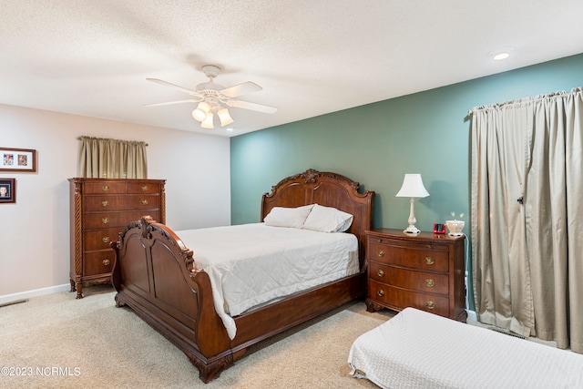 carpeted bedroom with a textured ceiling and ceiling fan