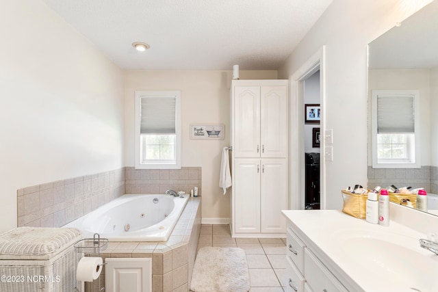 bathroom with a textured ceiling, vanity, tile patterned floors, and plenty of natural light