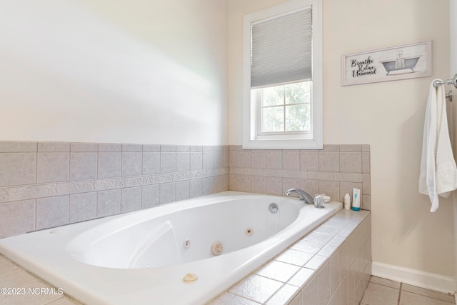 bathroom with tile patterned flooring and tiled bath