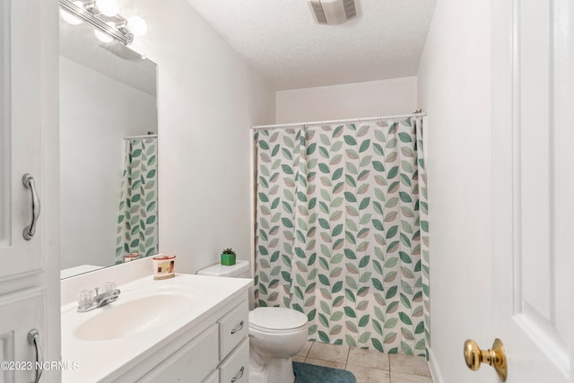 bathroom featuring vanity, tile patterned floors, a shower with shower curtain, toilet, and a textured ceiling