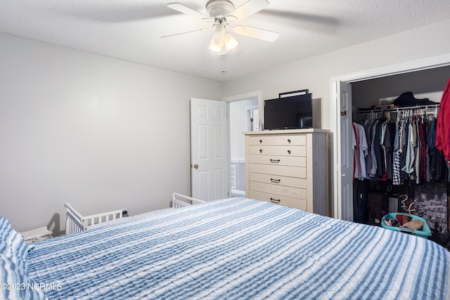 bedroom with a textured ceiling, a closet, and ceiling fan