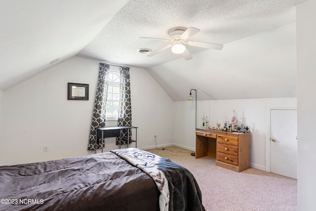 bedroom with ceiling fan, light colored carpet, lofted ceiling, and a textured ceiling