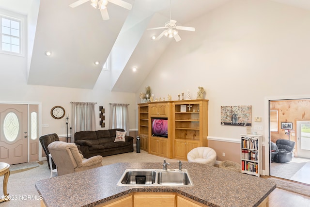 living room with ceiling fan, sink, and high vaulted ceiling