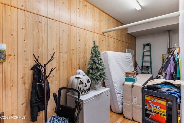 washroom featuring wooden walls and light hardwood / wood-style flooring