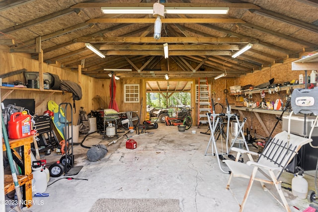 interior space with a workshop area and wood walls