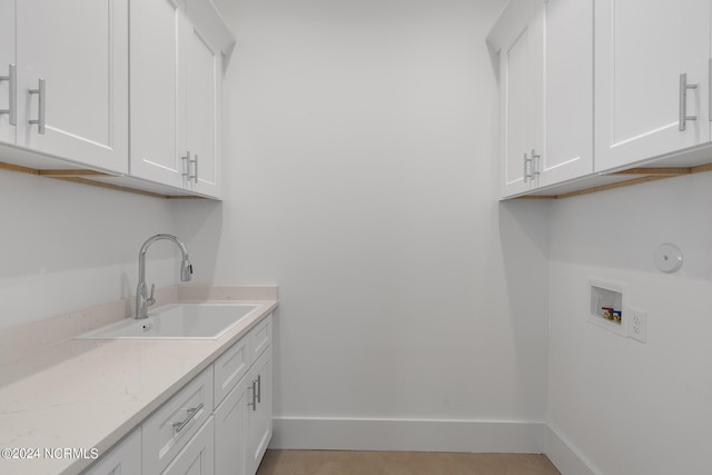 washroom featuring cabinets, washer hookup, and sink