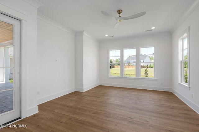 empty room with crown molding, ceiling fan, and dark hardwood / wood-style flooring