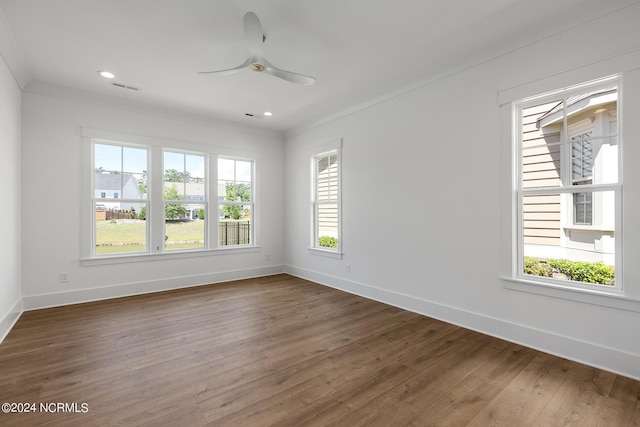 spare room featuring dark wood-type flooring, ceiling fan, and ornamental molding