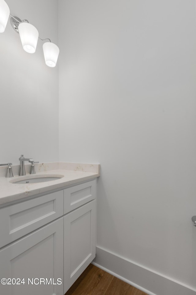 bathroom featuring hardwood / wood-style flooring and vanity